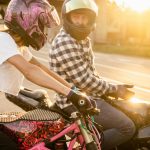 motorbike riders in city sitting on motorbikes at sunset