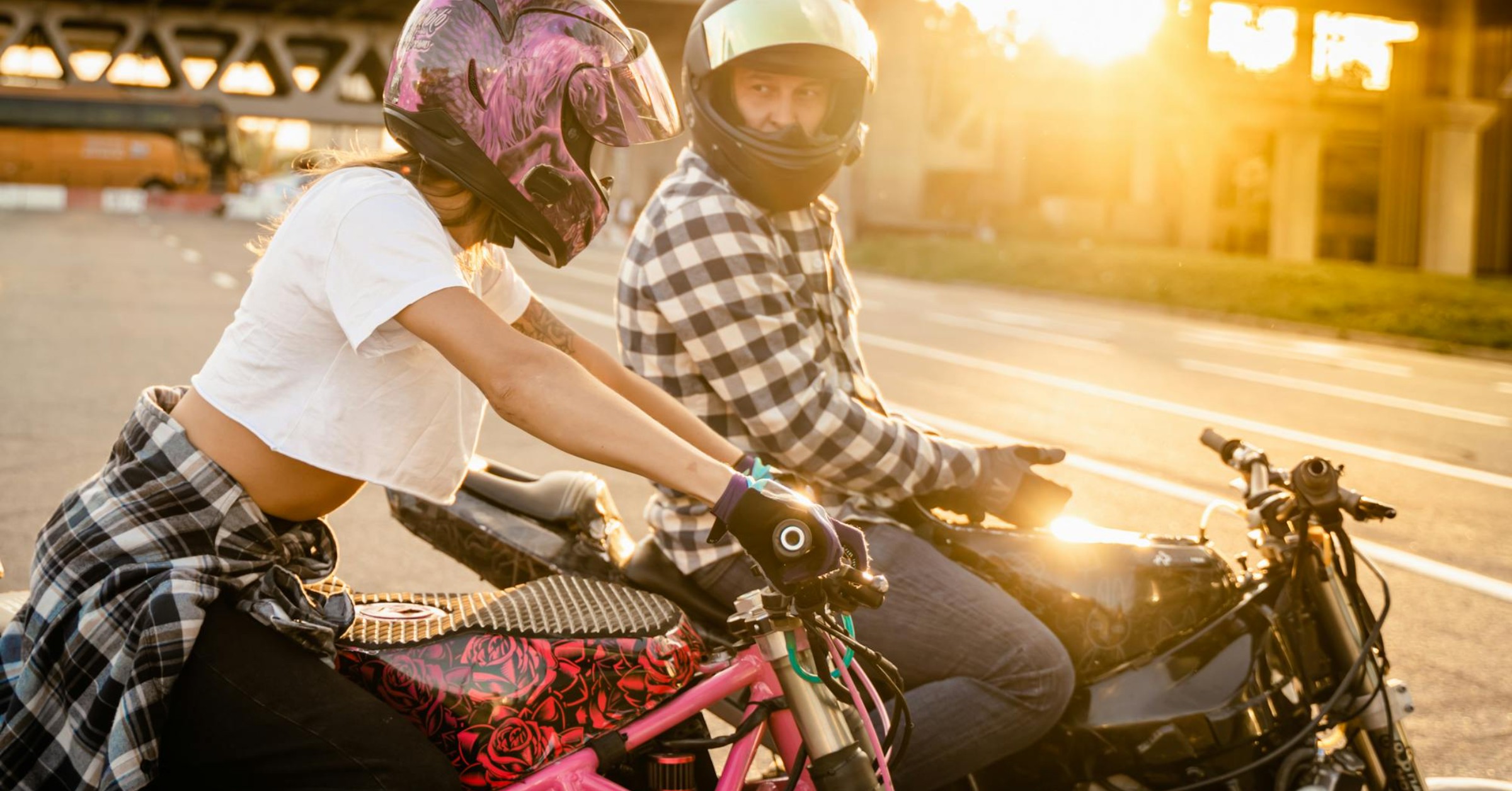 motorbike riders in city sitting on motorbikes at sunset